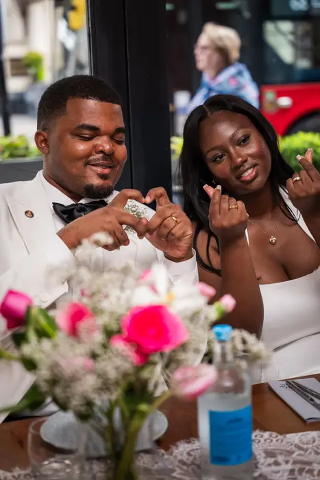 Bride and groom at the wedding reception table, photographed by Imisi Bamiro, Coventry photographer