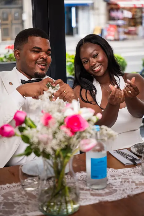 Bride and groom at the wedding reception table, photographed by Imisi Bamiro, Coventry photographer