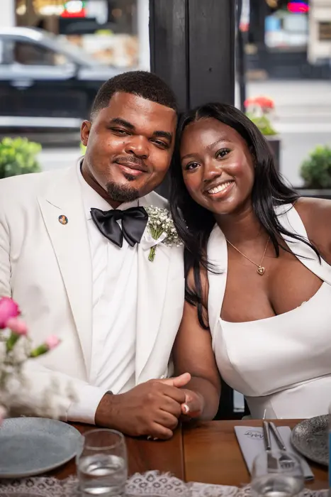 Bride and groom at the wedding reception table, photographed by Imisi Bamiro, Coventry photographer
