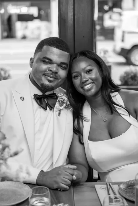 Bride and groom at the wedding reception table, photographed by Imisi Bamiro, Coventry photographer