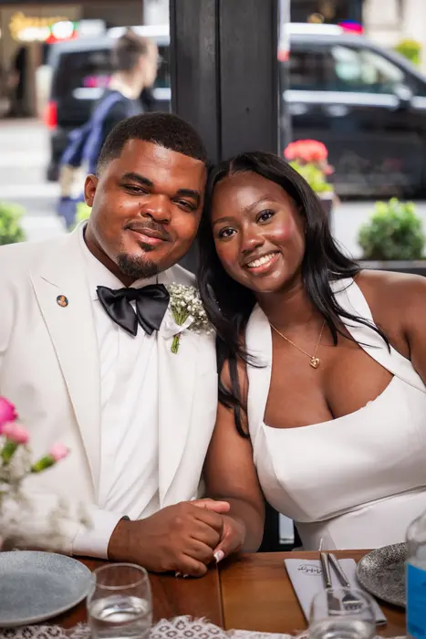 Bride and groom at the wedding reception table, photographed by Imisi Bamiro, Coventry photographer