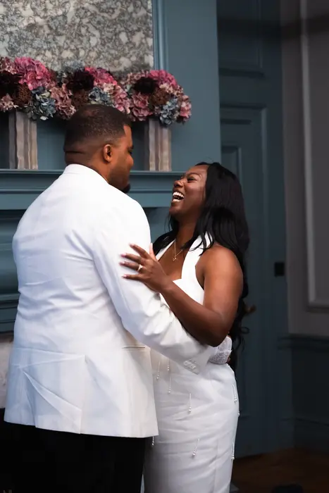 Bride and groom sharing a laugh after the wedding ceremony, photographed by Imisi Bamiro, Coventry photographer