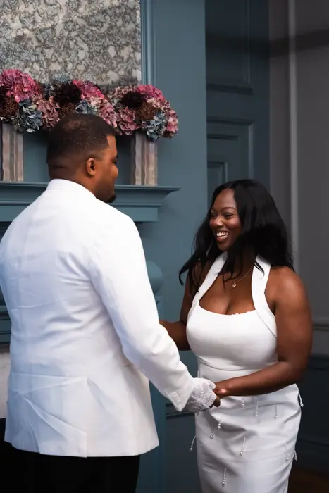 Bride and groom sharing a laugh after the wedding ceremony, photographed by Imisi Bamiro, Coventry photographer