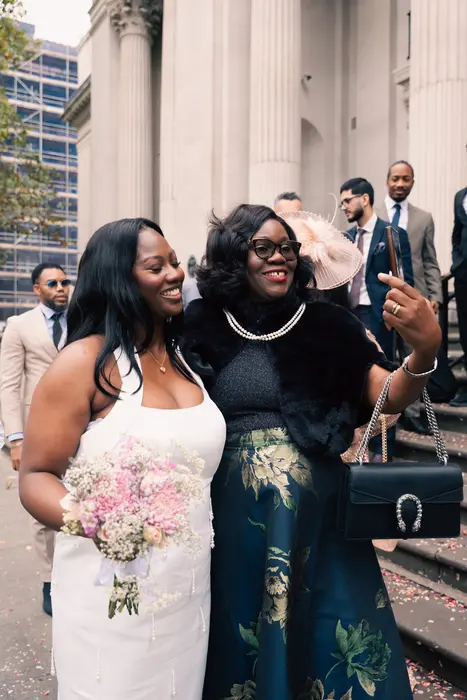 Bride hugging guests outside the wedding ceremony, photographed by Imisi Bamiro, Coventry photographer