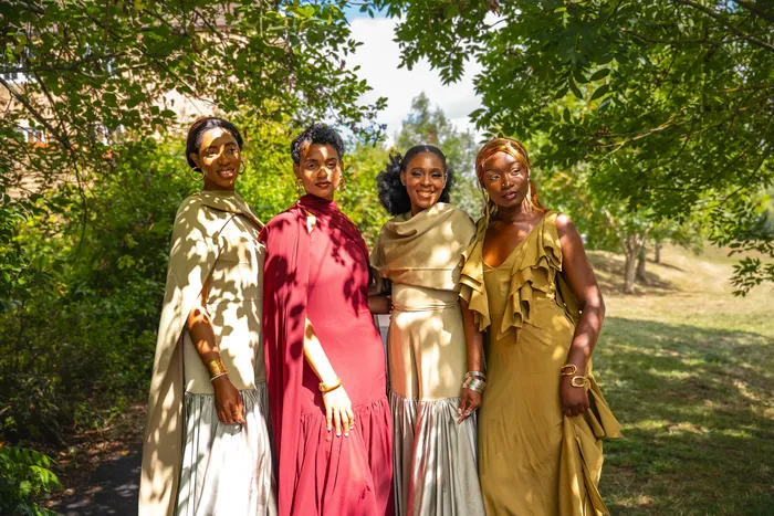 Group fashion shoot in satin gowns in a park, photographed by Imisi Bamiro, Coventry photographer