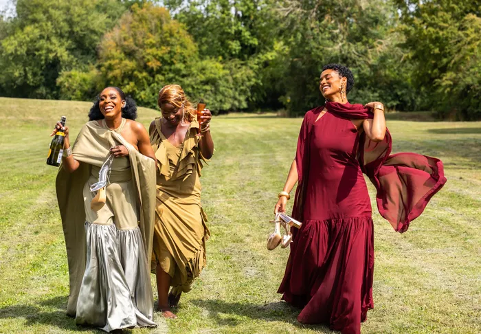 Group fashion shoot in satin gowns in a park, photographed by Imisi Bamiro, Coventry photographer