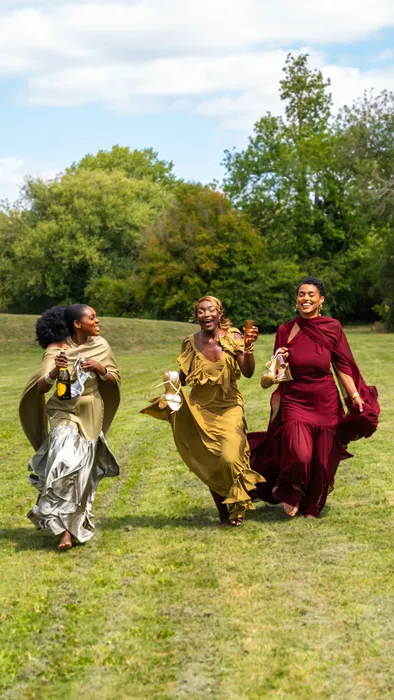 Group fashion shoot in satin gowns in a park, photographed by Imisi Bamiro, Coventry photographer
