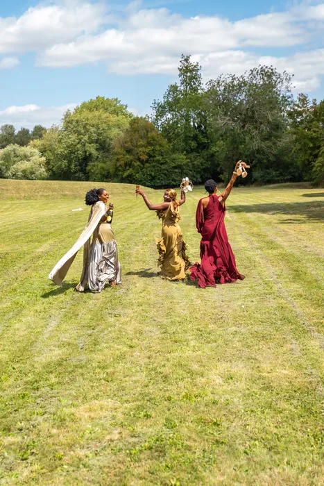 Group fashion shoot in satin gowns in a park, photographed by Imisi Bamiro, Coventry photographer