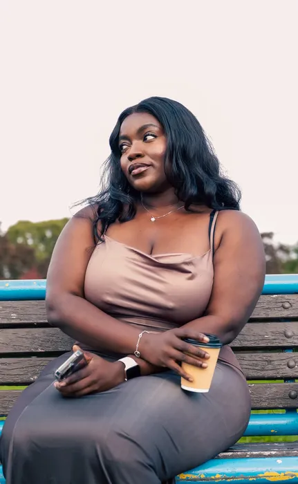 Lifestyle portrait of a woman in a nude dress outdoors, photographed by Imisi Bamiro, Coventry photographer