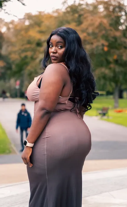 Lifestyle portrait of a woman in a nude dress outdoors, photographed by Imisi Bamiro, Coventry photographer