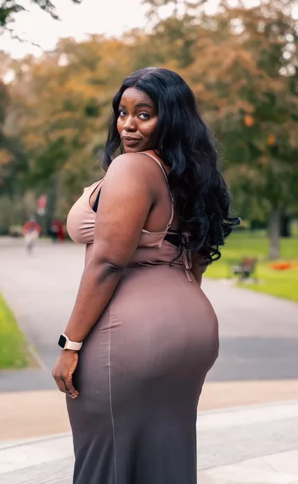 Lifestyle portrait of a woman in a nude dress outdoors, photographed by Imisi Bamiro, Coventry photographer