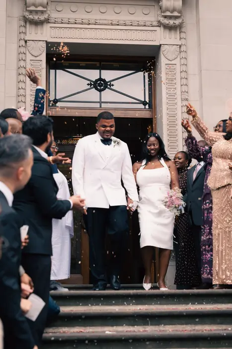 Newlyweds leaving the ceremony to cheers and confetti, photographed by Imisi Bamiro, Coventry photographer