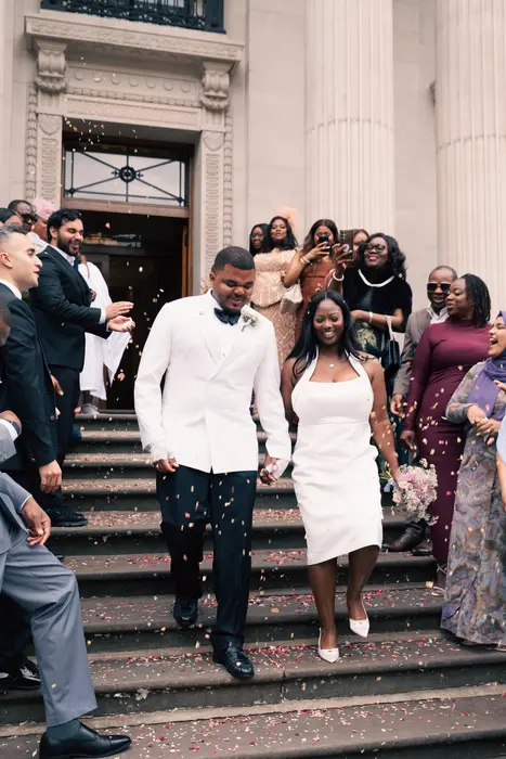 Newlyweds leaving the ceremony to cheers and confetti, photographed by Imisi Bamiro, Coventry photographer