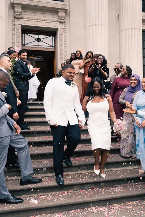 Newlyweds leaving the ceremony to cheers and confetti, photographed by Imisi Bamiro, Coventry photographer