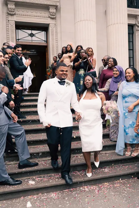 Newlyweds leaving the ceremony to cheers and confetti, photographed by Imisi Bamiro, Coventry photographer