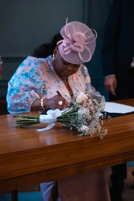 Signing the wedding register, photographed by Imisi Bamiro, Coventry photographer
