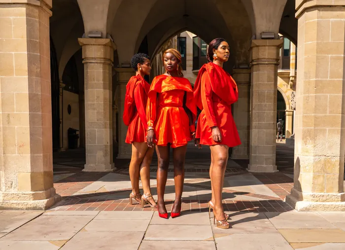 Three women in matching red dresses, fashion editorial, photographed by Imisi Bamiro, Coventry photographer