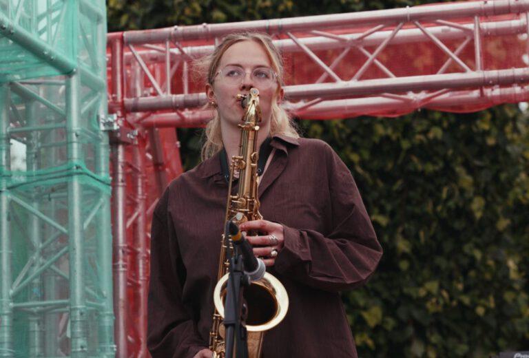 white girl playing saxophone